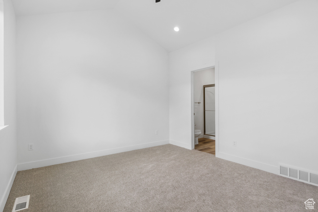 Empty room featuring visible vents, carpet, and baseboards