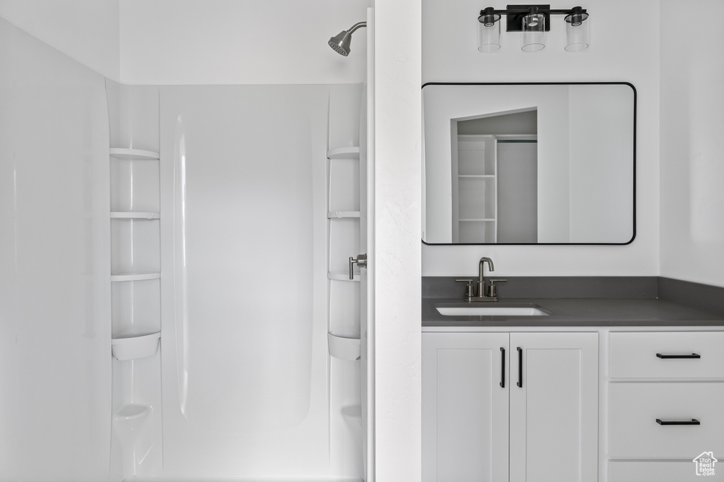 Full bath with walk in shower and vanity