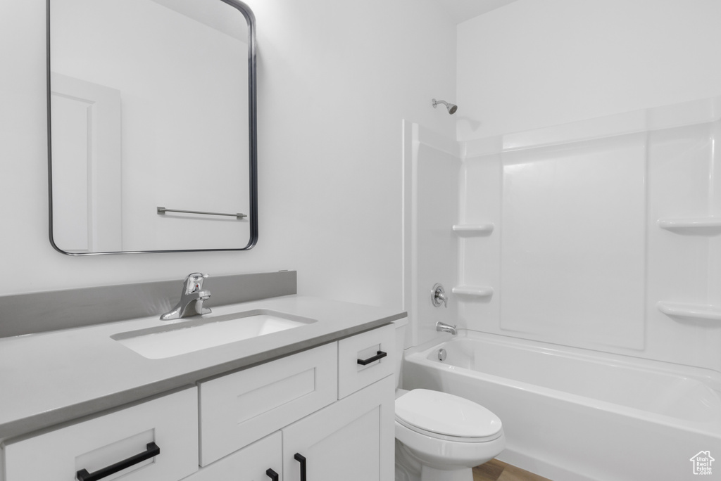 Full bathroom featuring shower / bathing tub combination, vanity, and toilet