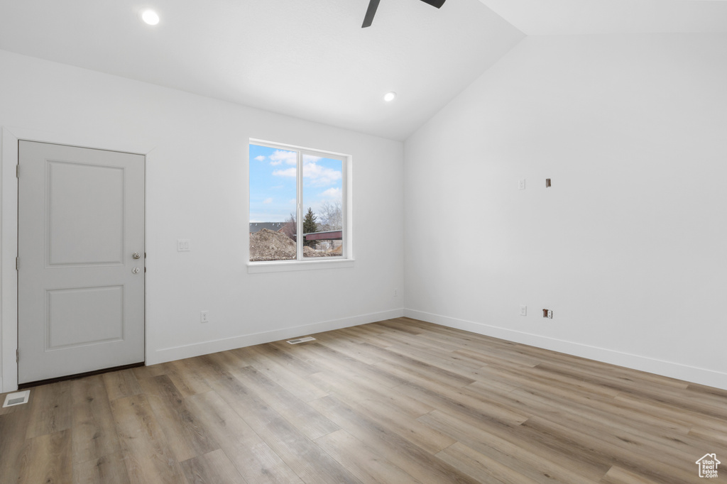 Unfurnished room featuring recessed lighting, a ceiling fan, light wood-style flooring, baseboards, and lofted ceiling