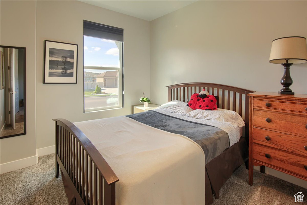 Carpeted bedroom with baseboards