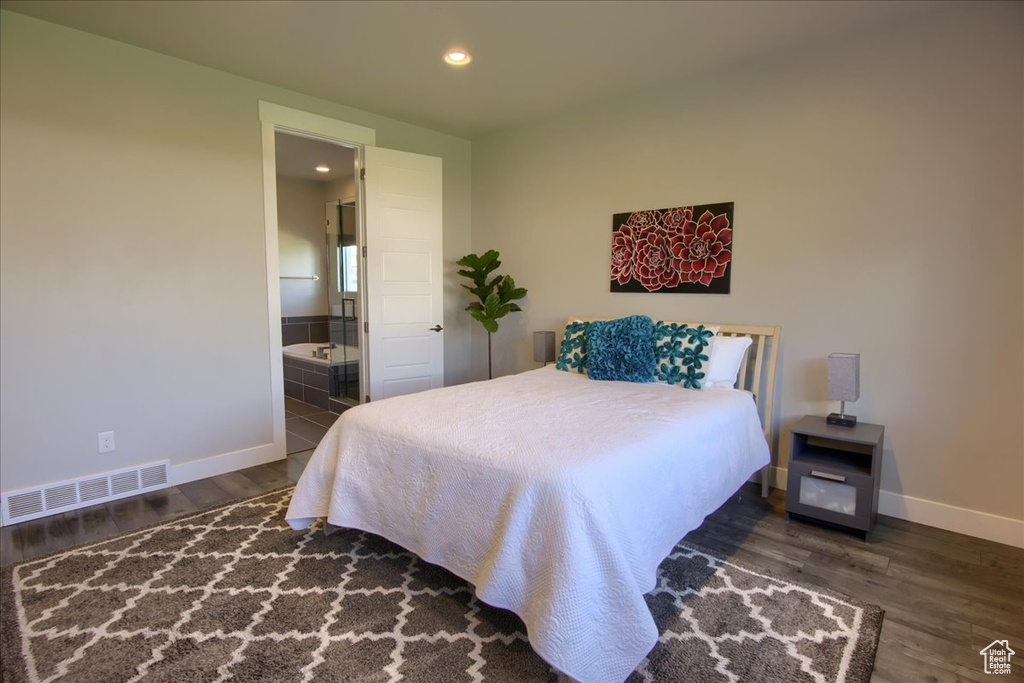 Bedroom with recessed lighting, baseboards, wood finished floors, ensuite bathroom, and visible vents