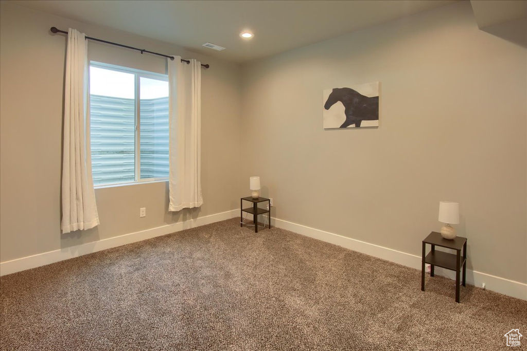 Carpeted empty room with baseboards, recessed lighting, and visible vents