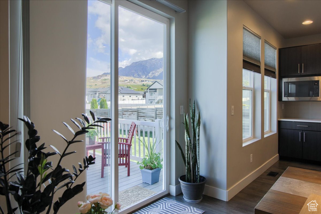 Entryway featuring baseboards, recessed lighting, a mountain view, and dark wood-style floors