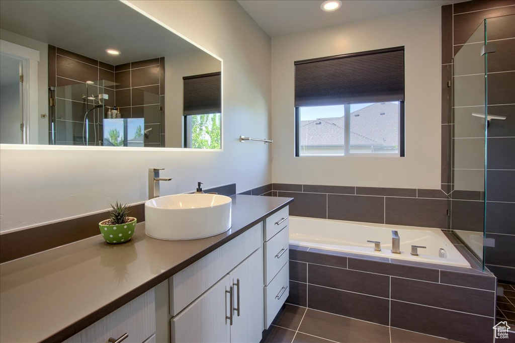 Full bath featuring vanity, a garden tub, tiled shower, recessed lighting, and tile patterned floors