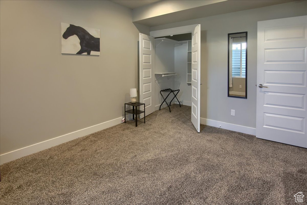Unfurnished bedroom featuring carpet floors and baseboards