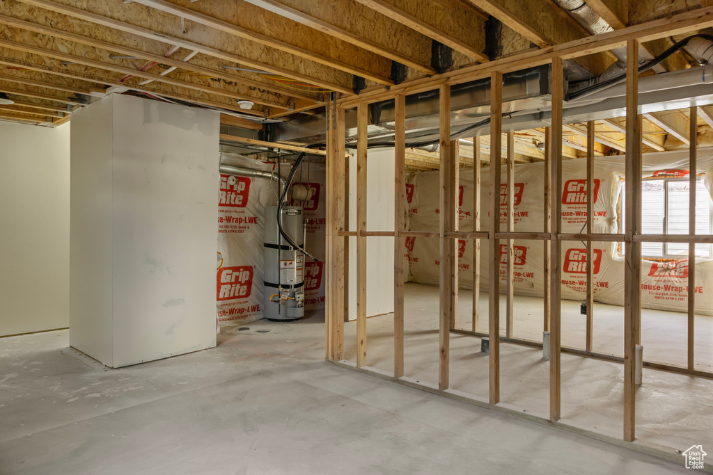 Unfinished basement featuring water heater