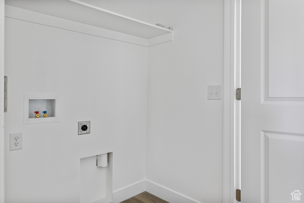 Laundry room featuring hookup for an electric dryer, washer hookup, baseboards, dark wood-type flooring, and laundry area