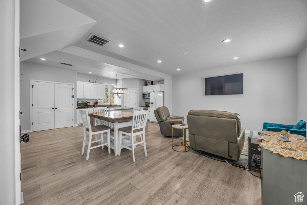 Dining space with recessed lighting, visible vents, and light wood-style floors