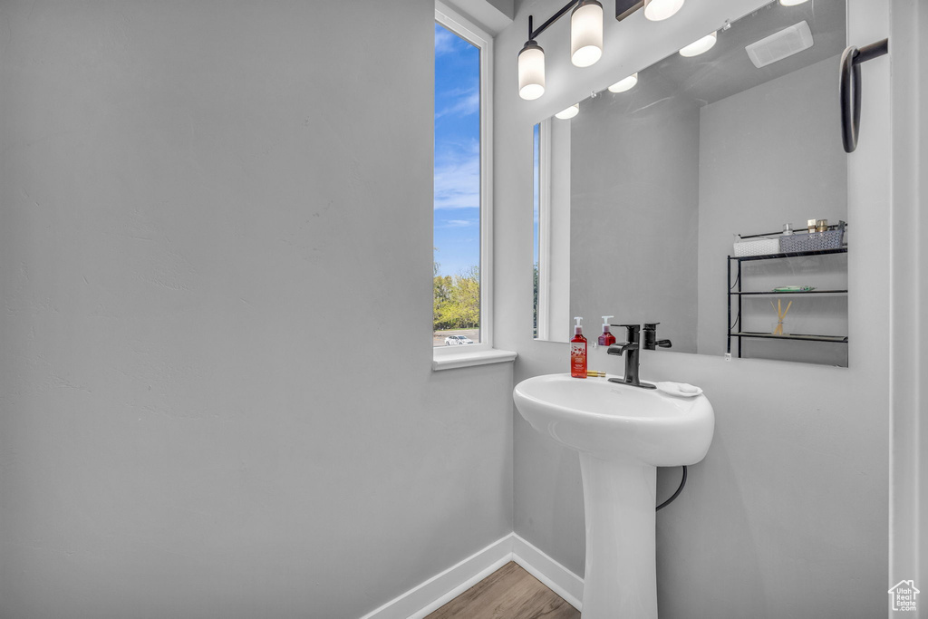 Bathroom with baseboards and wood finished floors