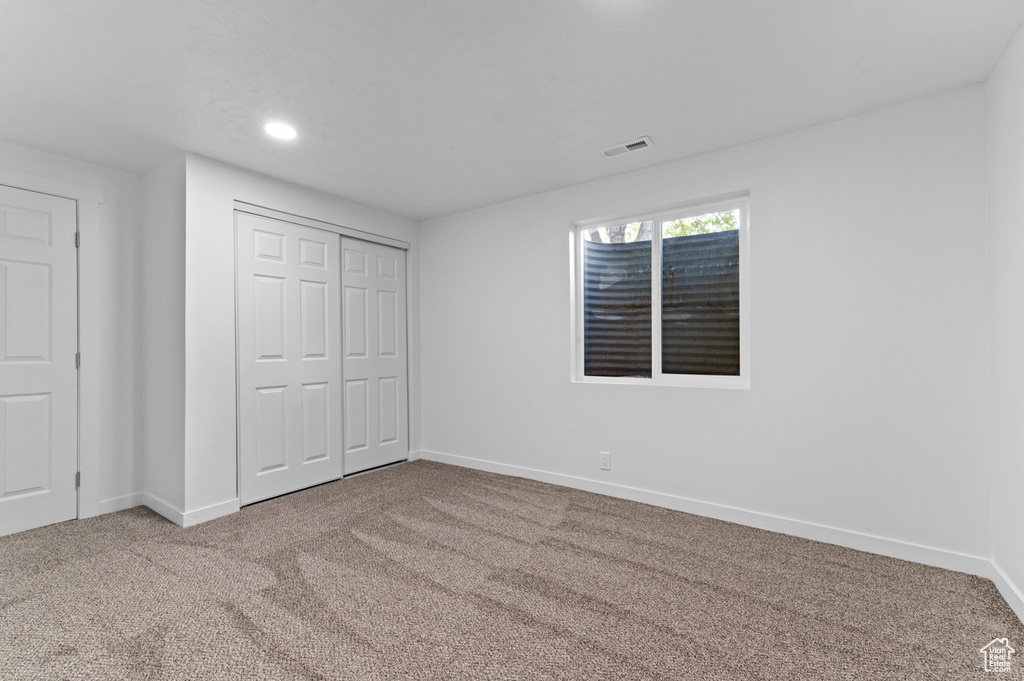 Unfurnished bedroom featuring baseboards, recessed lighting, carpet floors, and visible vents