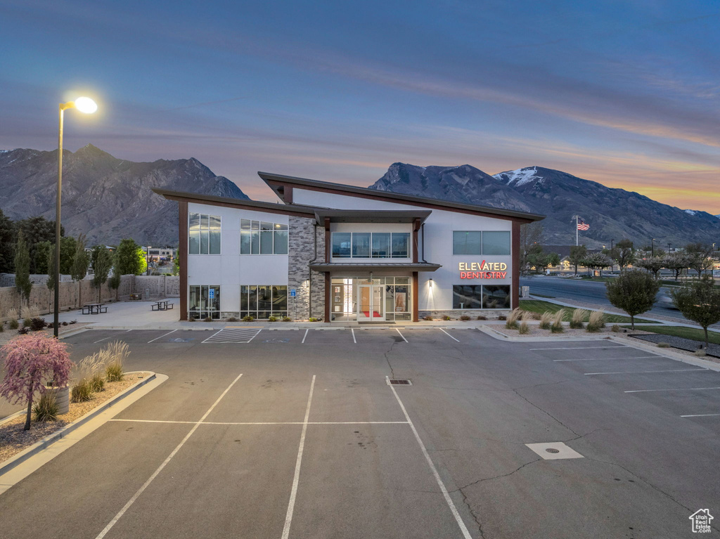 Exterior space with uncovered parking and a mountain view