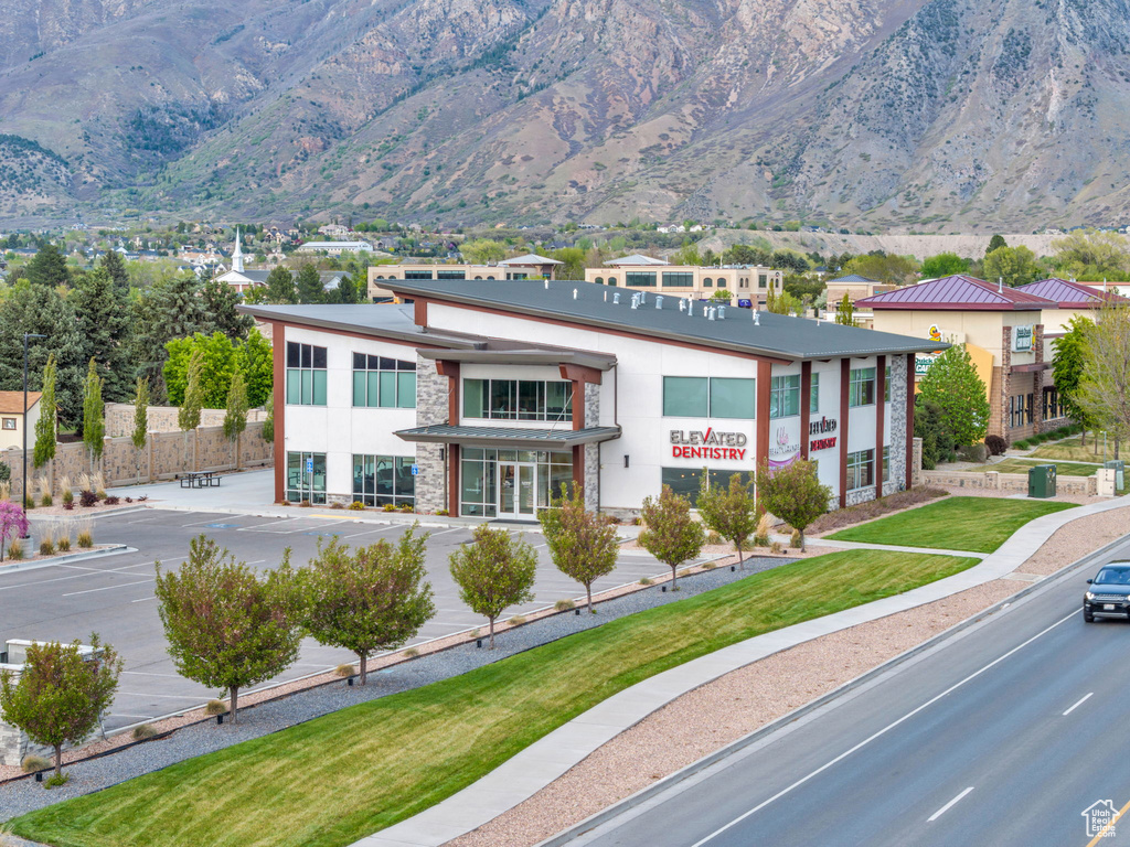 Exterior space featuring a mountain view, stone siding, and stucco siding