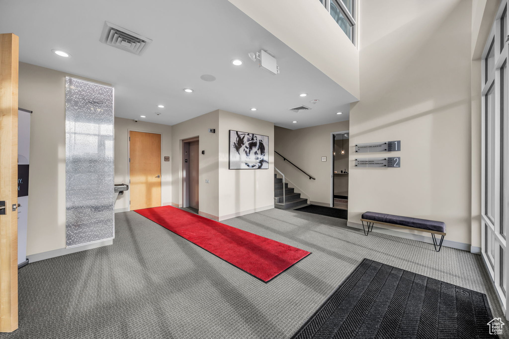 Building lobby featuring stairs and visible vents