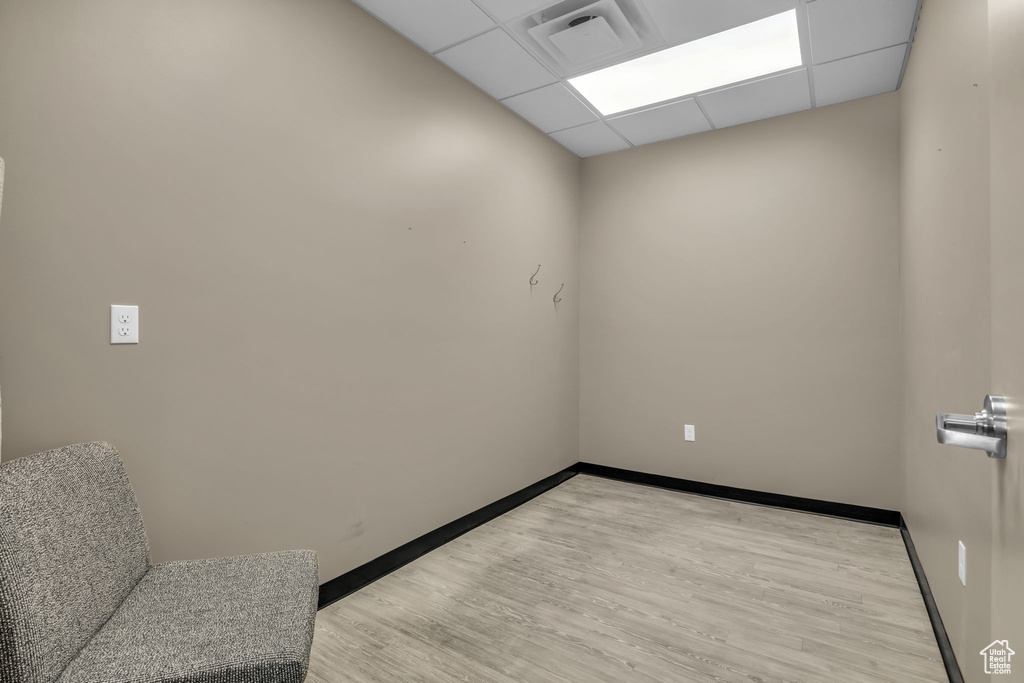 Spare room featuring visible vents, a paneled ceiling, and light wood-style floors
