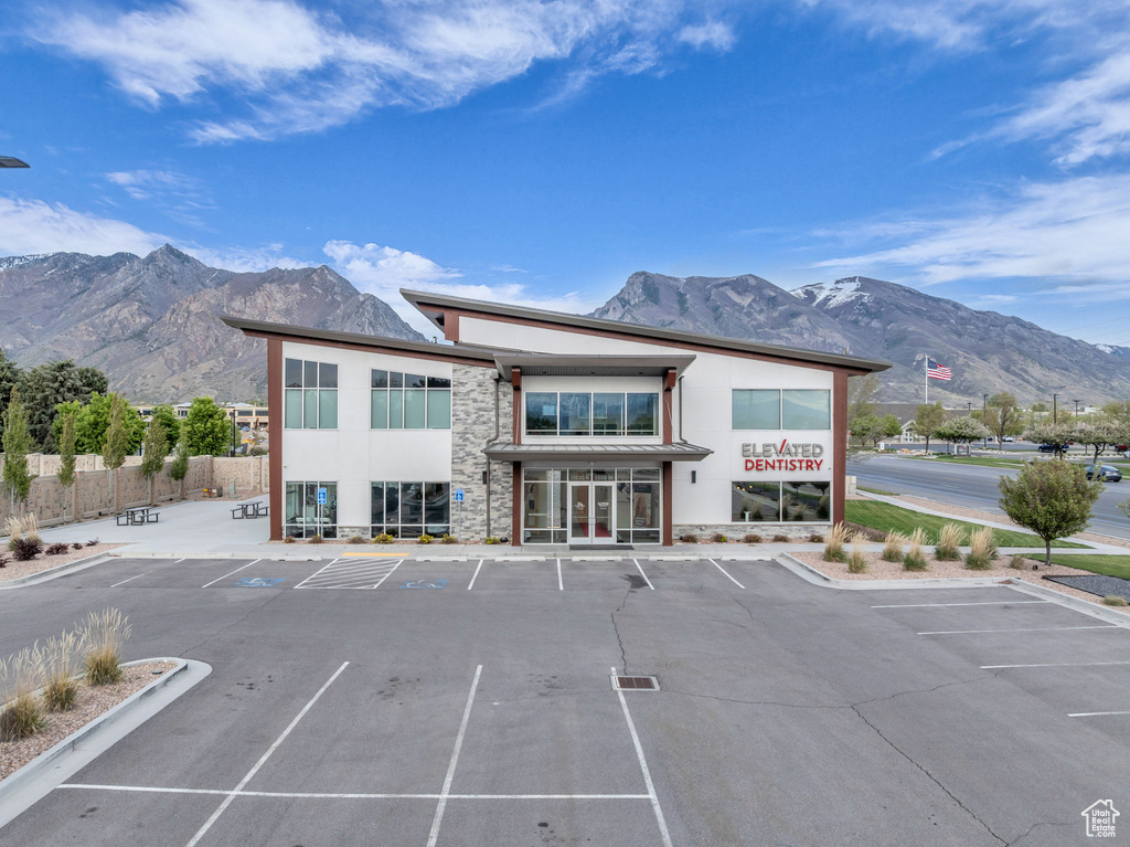Exterior space with uncovered parking and a mountain view