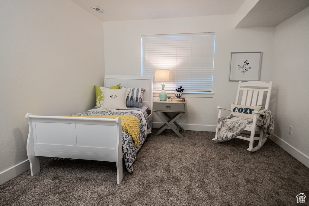 Carpeted bedroom with visible vents and baseboards
