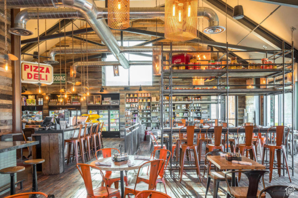 Dining space featuring hardwood / wood-style floors and high vaulted ceiling