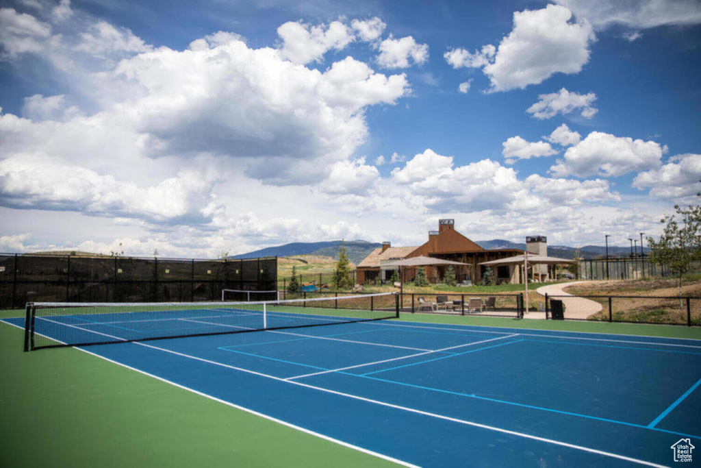 View of sport court with fence and a mountain view