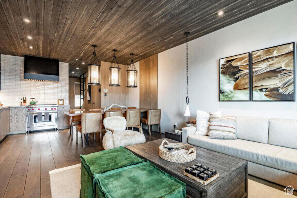 Living room featuring wood-type flooring, recessed lighting, and wooden ceiling