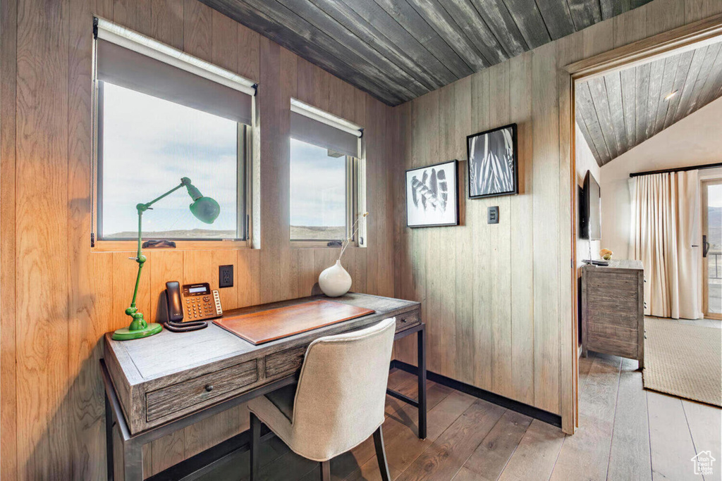 Office featuring wooden walls, wood ceiling, light wood-type flooring, and a wealth of natural light