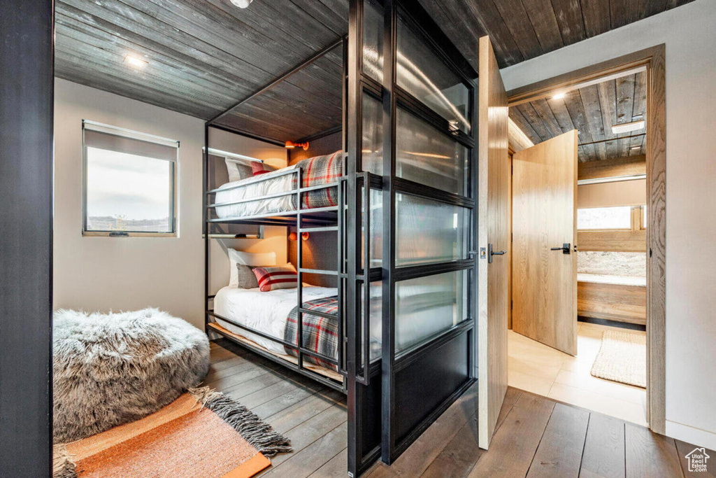 Bedroom featuring wood ceiling and hardwood / wood-style flooring