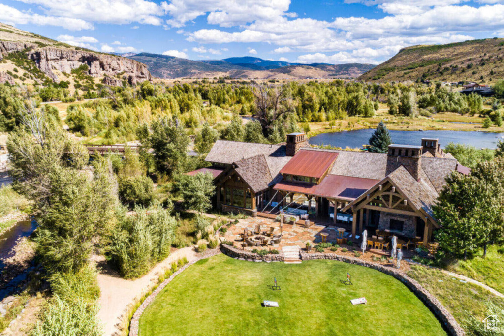 Drone / aerial view with a water and mountain view