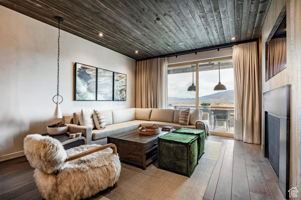 Living area featuring recessed lighting, wood ceiling, hardwood / wood-style flooring, and a fireplace