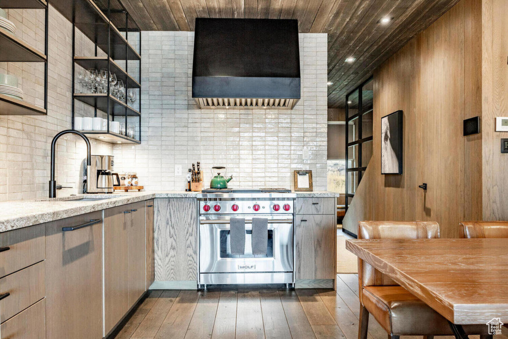 Kitchen with open shelves, dark wood finished floors, premium range hood, wooden ceiling, and premium range