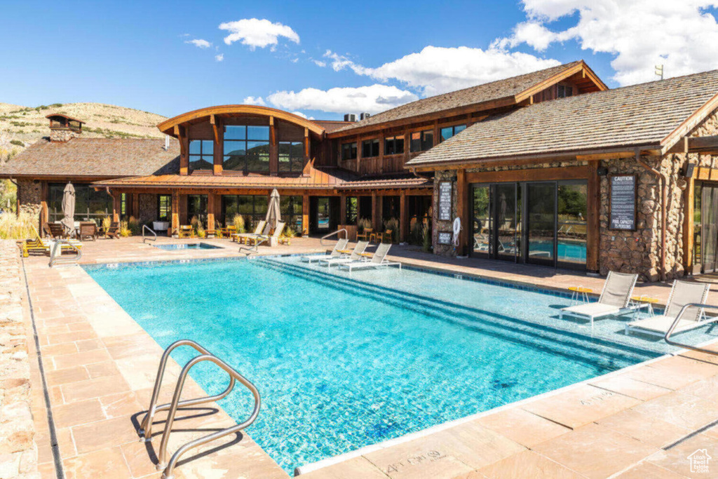 Pool featuring a patio and a hot tub