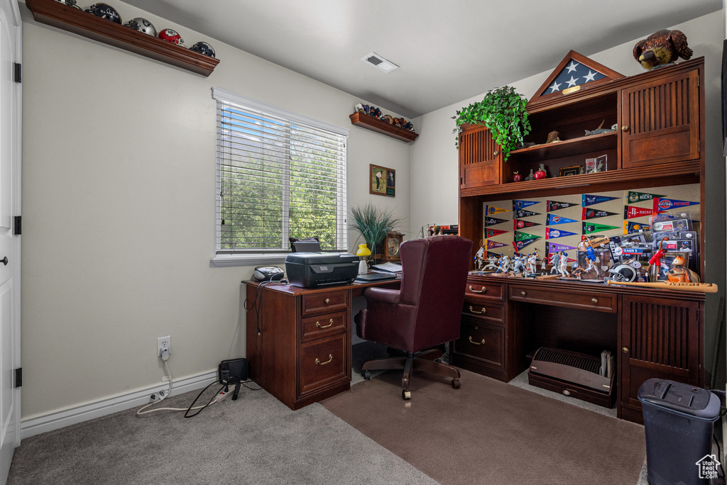 Home office featuring visible vents and carpet