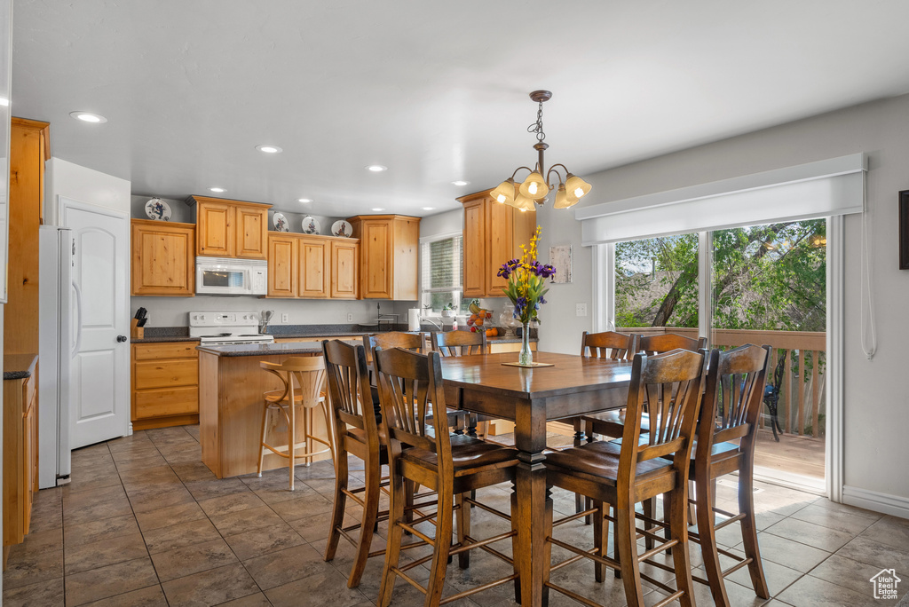 Dining area featuring recessed lighting and an inviting chandelier