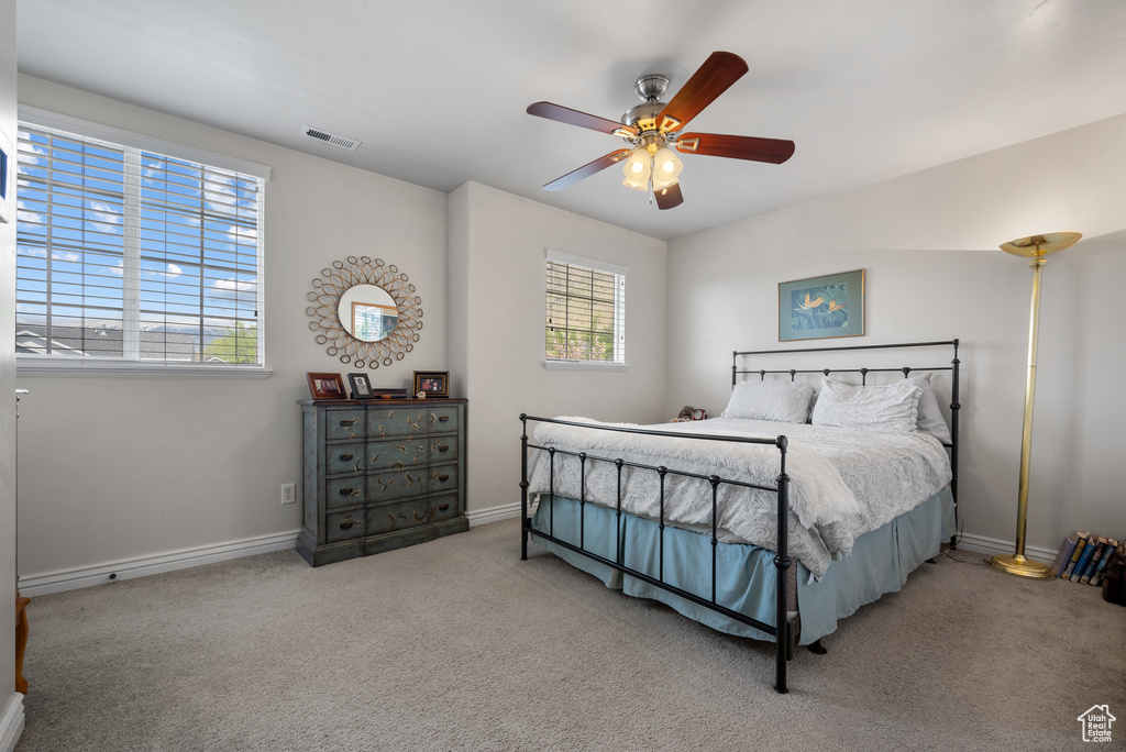 Bedroom with baseboards, carpet, and visible vents