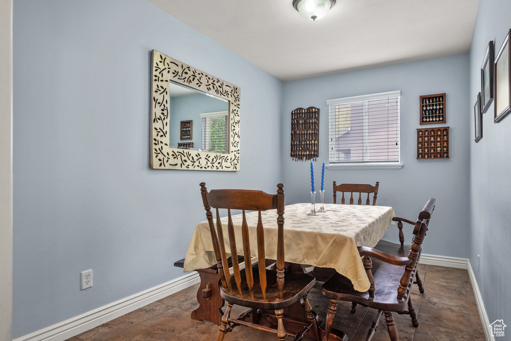 Dining room with baseboards and stone finish floor