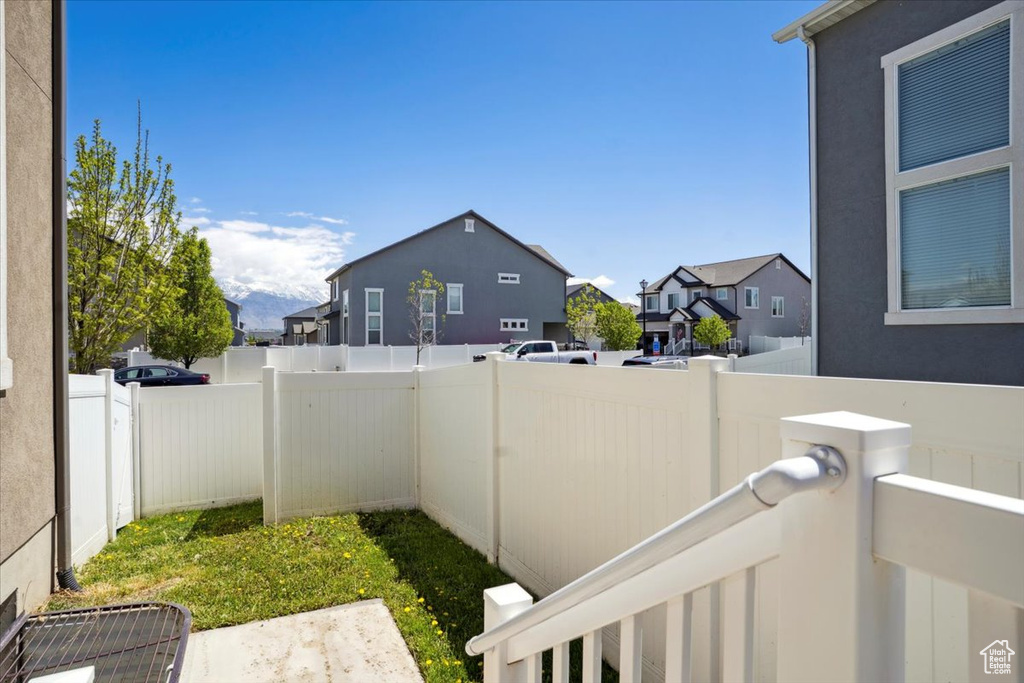 View of yard with a residential view and fence