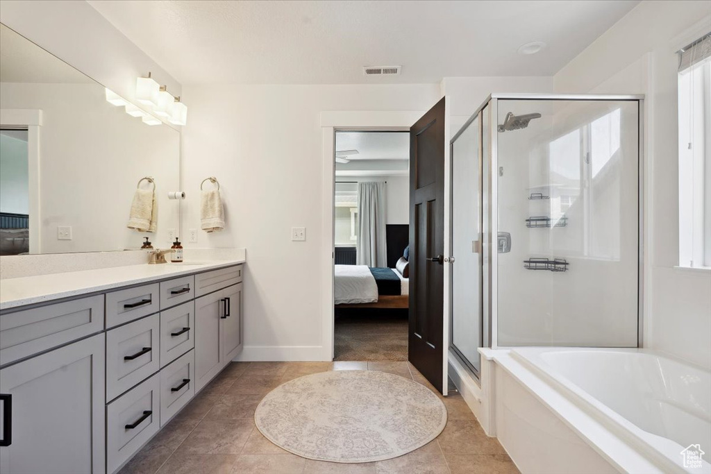 Bathroom with visible vents, a garden tub, vanity, connected bathroom, and a stall shower