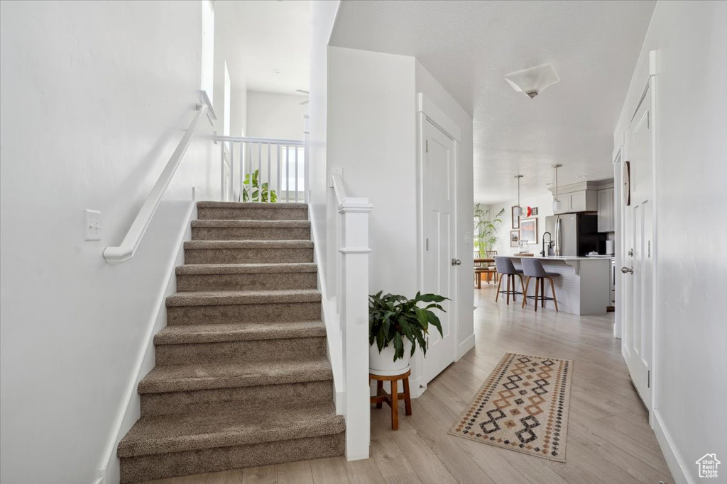 Stairs featuring baseboards and wood finished floors