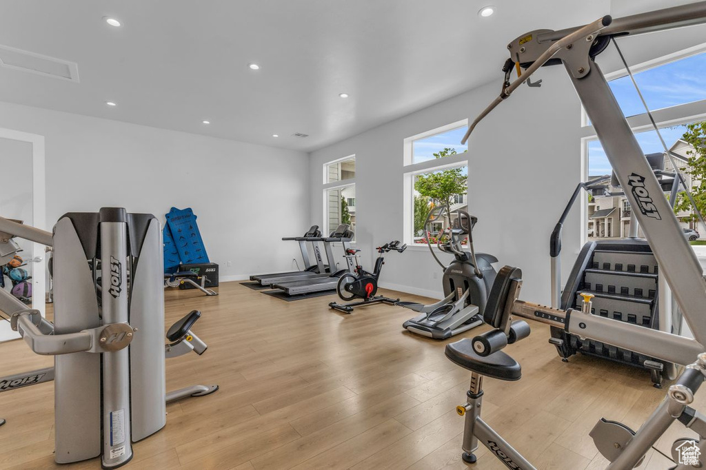 Workout area featuring baseboards, recessed lighting, wood finished floors, and visible vents