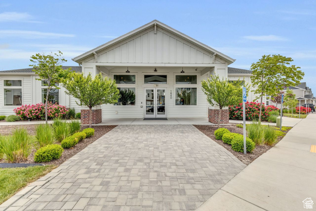 View of property featuring decorative driveway