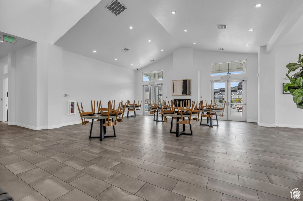 Dining area with high vaulted ceiling, baseboards, recessed lighting, and visible vents
