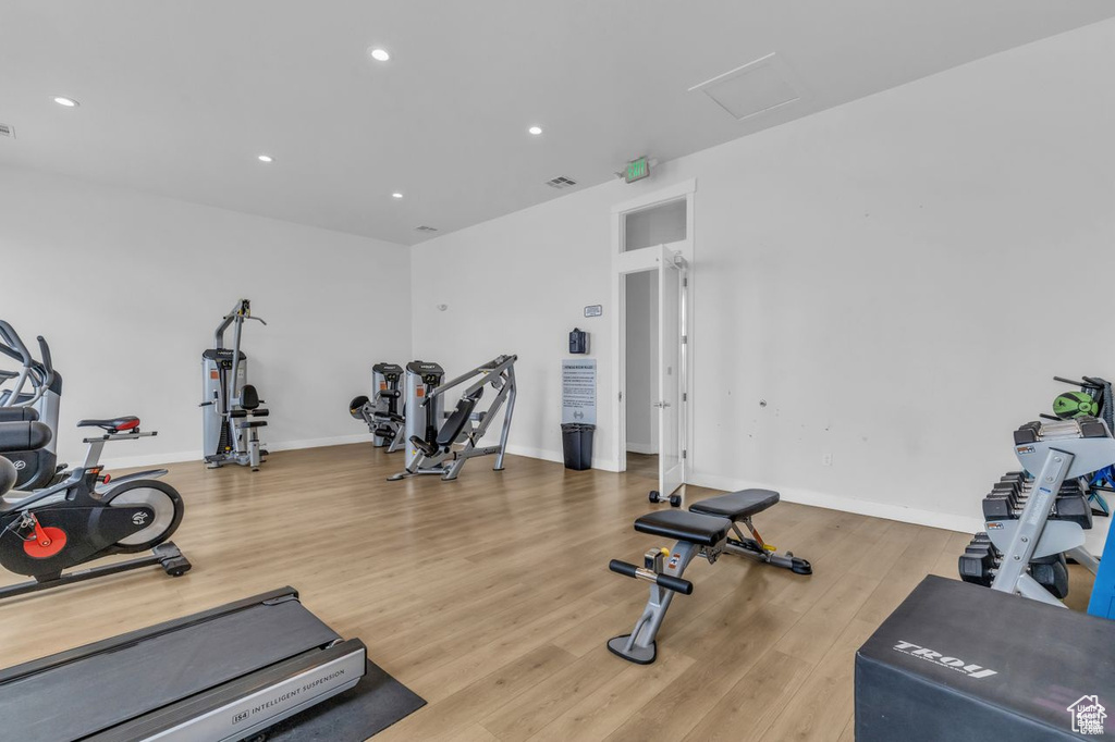 Interior space featuring recessed lighting, baseboards, wood finished floors, and attic access