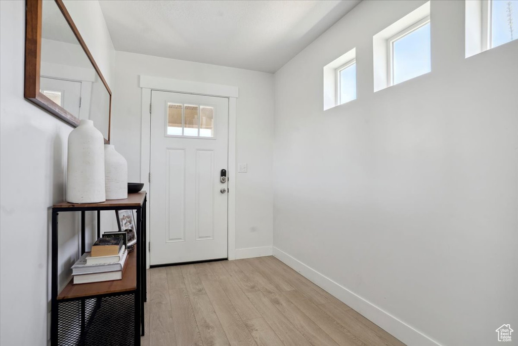 Foyer featuring baseboards and light wood-style flooring