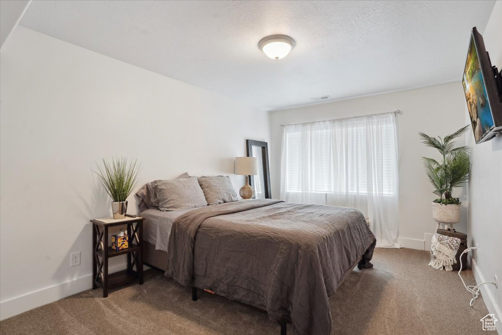 Bedroom featuring carpet floors and baseboards