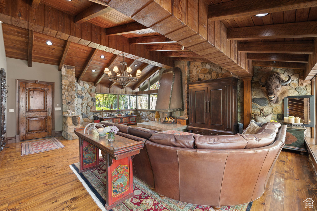 Living room featuring wooden ceiling, beamed ceiling, an inviting chandelier, recessed lighting, and hardwood / wood-style floors