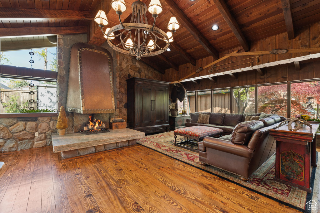 Living area with a notable chandelier, high vaulted ceiling, hardwood / wood-style floors, beamed ceiling, and wood ceiling