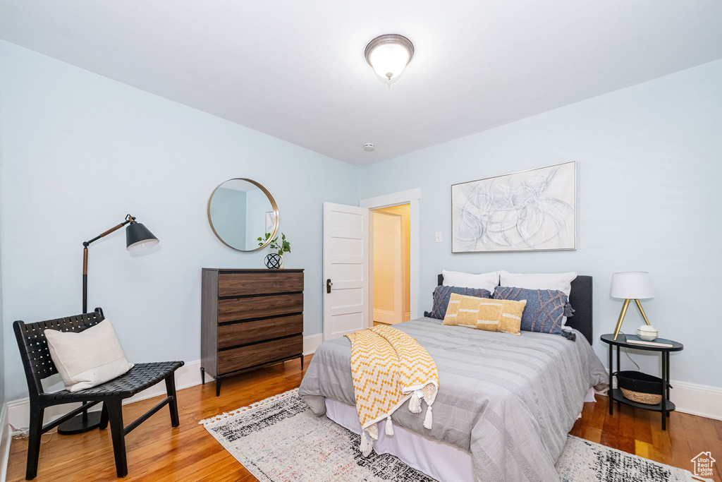 Bedroom with baseboards and wood finished floors