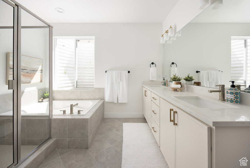 Bathroom with double vanity, an enclosed shower, a bath, tile patterned floors, and a sink