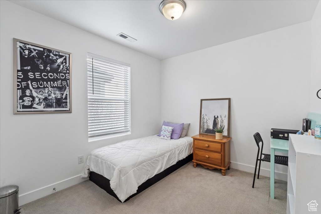 Bedroom featuring carpet and baseboards