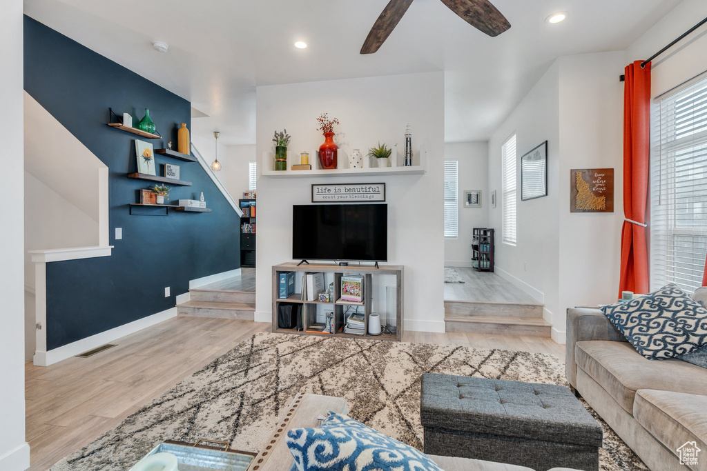 Living room with ceiling fan, recessed lighting, wood finished floors, and visible vents