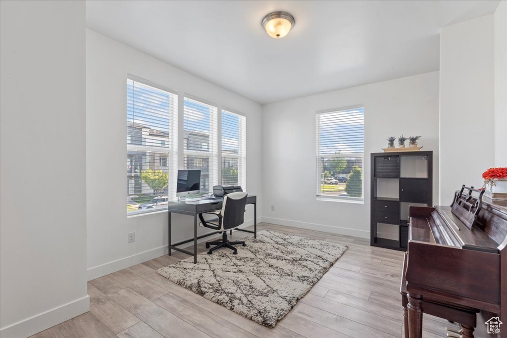 Office area featuring baseboards and wood finished floors